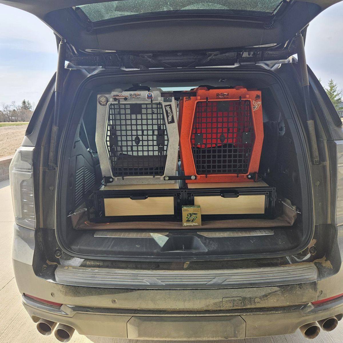 TNT Auto Drawer for Chevrolet Tahoe, GMC Yukon, Cadillac Escalade & Blazer — two dog crates, one silver and one orange, mounted inside the open trunk of a beige SUV drawers in chevrolet tahoe outdoors.