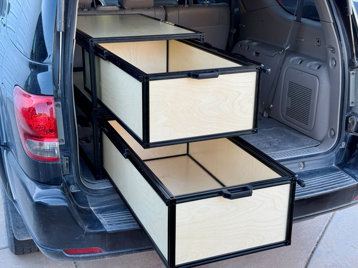 Stacked TNT Auto Drawers open in an SUV cargo area