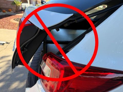 Rear SUV hatch contacting a cargo drawer that is too tall for the opening
